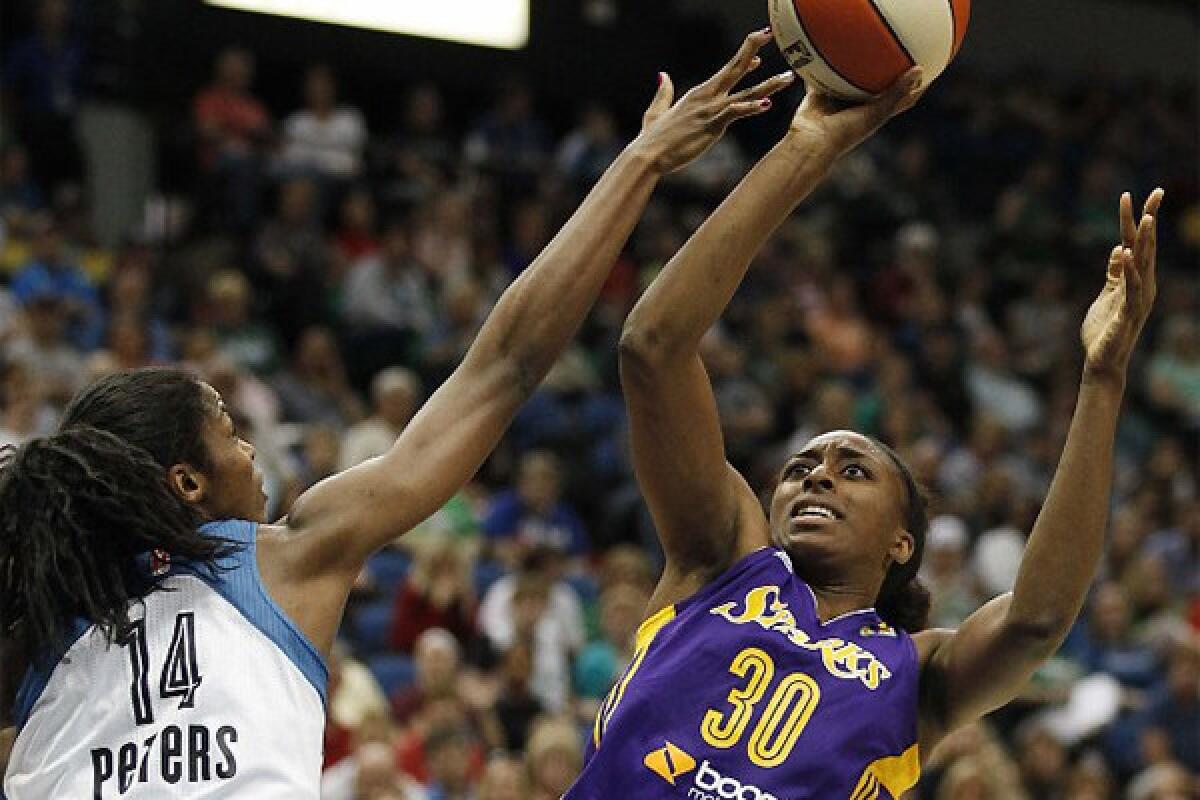Sparks rookie Nneka Ogwumike shoots over the Lynx's Devereaux Peters during the first half of L.A.'s matchup against Minnesota on June 28, 2013.