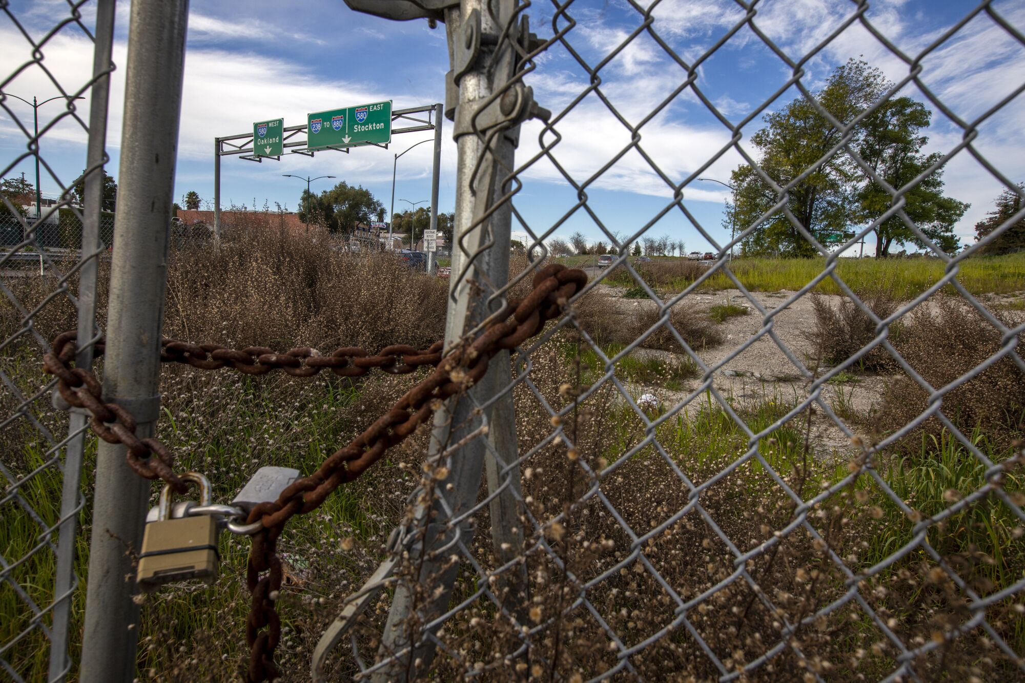 A view of the would-be freeway corridor through a gate in a field near Foothill Boulevard and Apple Avenue in Hayward. 
