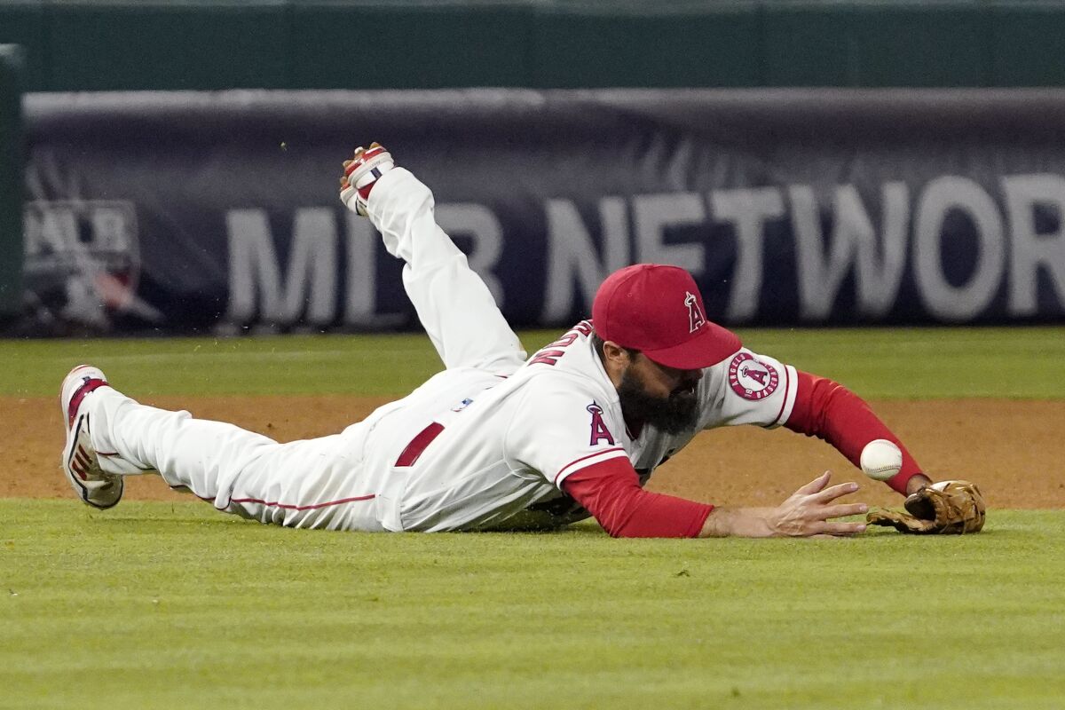 Los Angeles Angels third baseman Anthony Rendon dives for a ball that was hit for a single by New York Mets' Luis Guillorme during the eighth inning of a baseball game Friday, June 10, 2022, in Anaheim, Calif. (AP Photo/Mark J. Terrill)