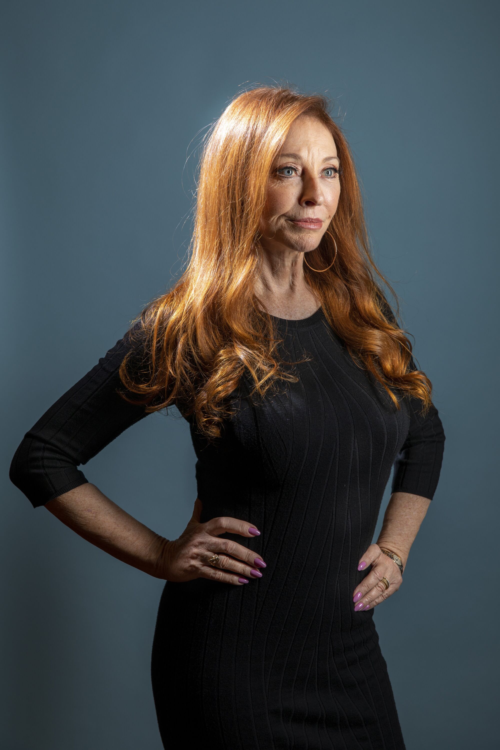 Cassandra Peterson poses with hands on her hips in 2021. 
