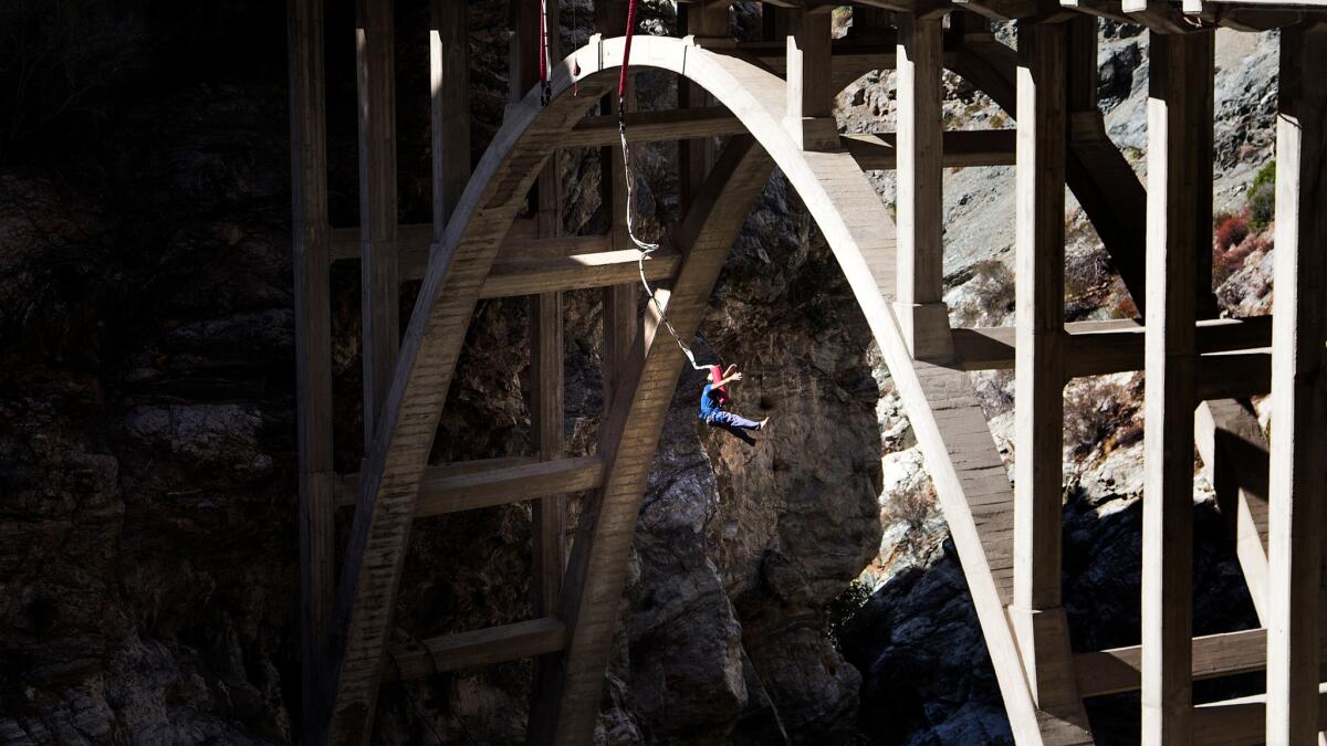 A bungee jumper dangles over the San Gabriel River after doing a backward plunge off the Bridge To Nowhere.