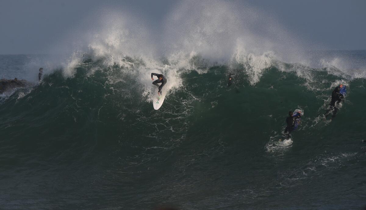 A surfer drops into the peak of a giant wave at the Wedge in Newport Beach on May 16, 2019.