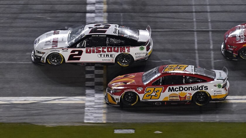 Austin Cindric crosses the finish line ahead of Bubba Wallace to win the Daytona 500.