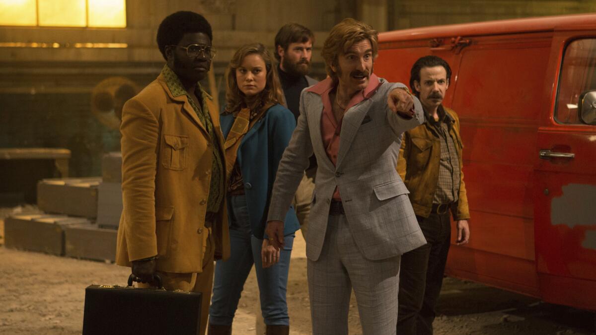 Sharlto Copley, pointing, in the shoot 'em up "Free Fire," with from left, Babou Ceesay, Brie Larson, Armie Hammer and Noah Taylor.