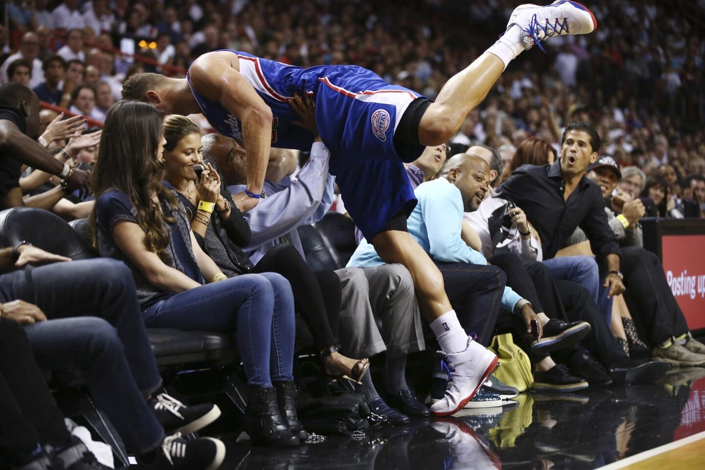 Clippers power forward Blake Griffin lands in the front row while chasing down a loose ball in the second half Thursday night in Miami.