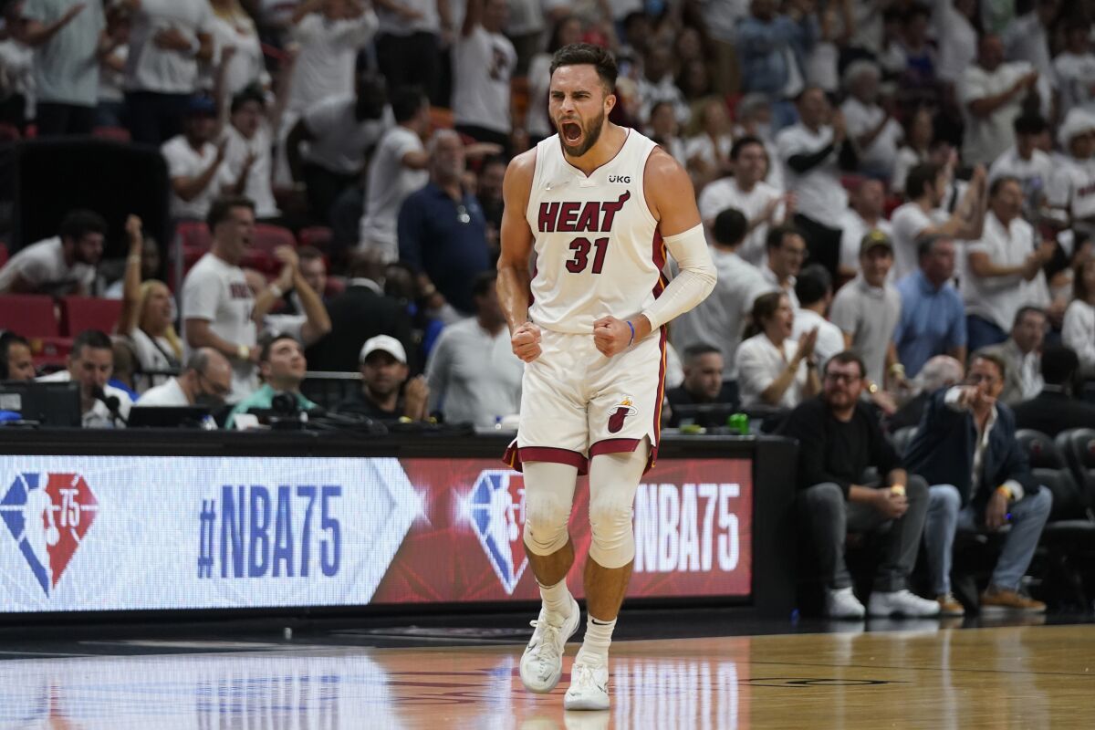 Miami Heat guard Max Strus (31) celebrates after scoring a three-point shot during the first half of Game 5 of an NBA basketball second-round playoff series against the Philadelphia 76ers, Tuesday, May 10, 2022, in Miami. (AP Photo/Wilfredo Lee)