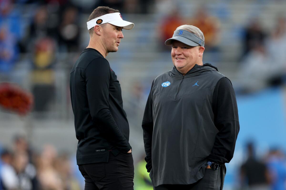 USC coach Lincoln Riley and UCLA coach Chip Kelly talk before last year’s game between their schools at the Rose Bowl.