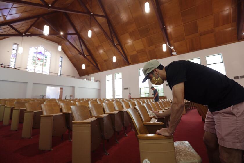 Alamo Heights Baptist Church pastor Bobby Contreras, right, works to clean, sanitize and prepare his church for services this Sunday, in San Antonio, Wednesday, May 6, 2020,. Texas' stay-at-home orders due to the COVID-19 pandemic have expired and Texas Gov. Greg Abbott has eased restrictions on many businesses that have now opened, churches and places or worship may resume live services with 25% capacity. (AP Photo/Eric Gay)