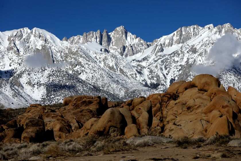 LONE PINE, CA - MARCH 23: Mount Whitney, the highest mountain in the contiguous United States and the Sierra Nevada, with an elevation of 14,505 feet, is located on the east side of the Sierra Nevada mountain range, with the Alabama Hills, foreground, shown from Whitney Portal Road on Thursday, March 23, 2023 in Lone Pine, CA. Flash flooding along the eastern Sierra Nevada a week ago caused an unprecedented breach in the City of Los Angeles Department of Water and Power Los Angeles Aqueduct, as well as other damage. (Gary Coronado / Los Angeles Times)