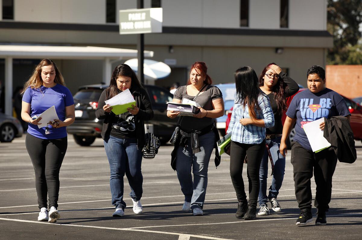Students at Everest College in Alhambra leave the campus with paperwork on loan forgiveness in April, after Corinthian Colleges abruptly shut down its remaining campuses. The U.S. Department of Education announced an expanded student debt relief plan in June.