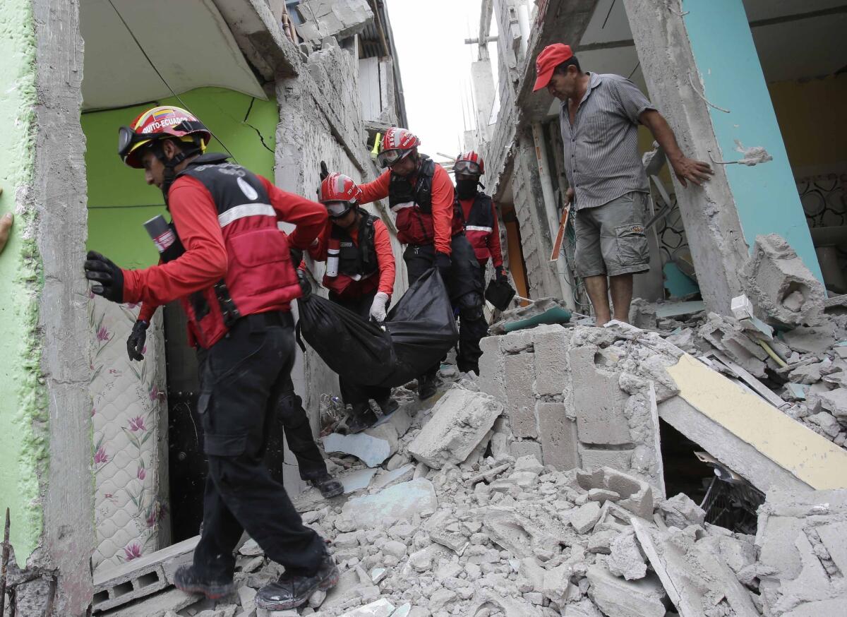 Firemen carry a body from a collapsed building in Pedernales, Ecuador. Rescuers pulled survivors from rubble Sunday after the strongest earthquake to hit Ecuador in decades flattened buildings and buckled highways along its Pacific coast.