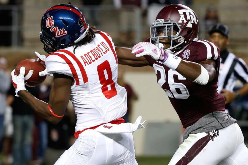 Mississippi Quincy Adeboyejo (8) hauls in a 33-yard touchdown past Texas A&M defensive back Devonta Burns (26) in the third quarter Saturday.