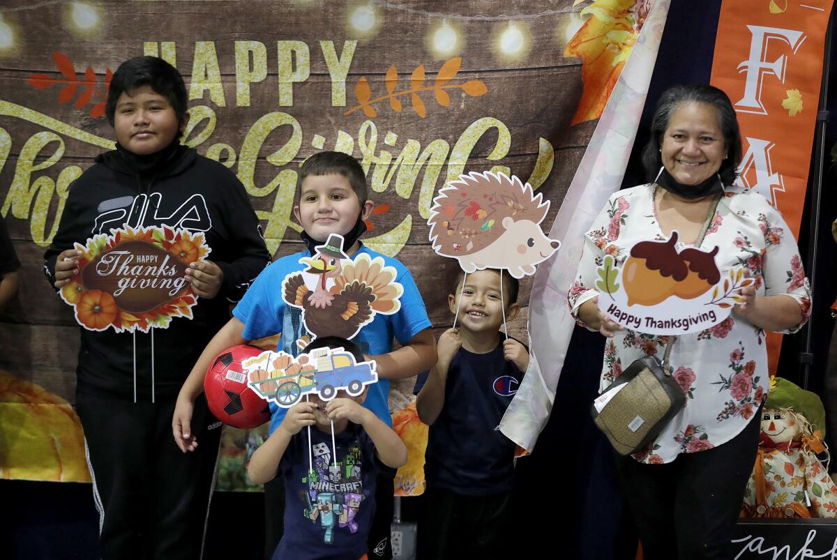 The Chavez-Hernandez family pauses for a photo at the Santa Ana Boys and Girl's Club on Tuesday.