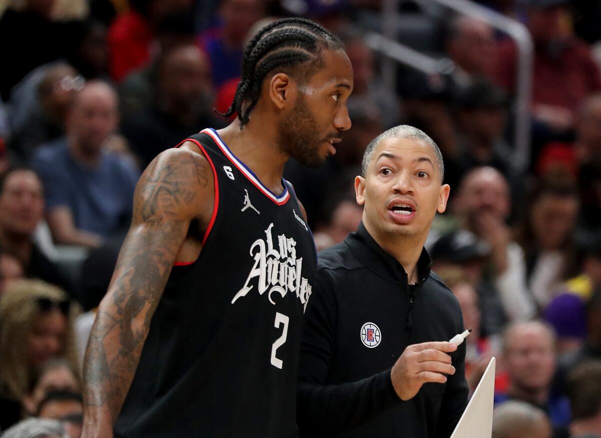 Clippers forward Kawhi Leonard talks with coach Tyronn Lue.