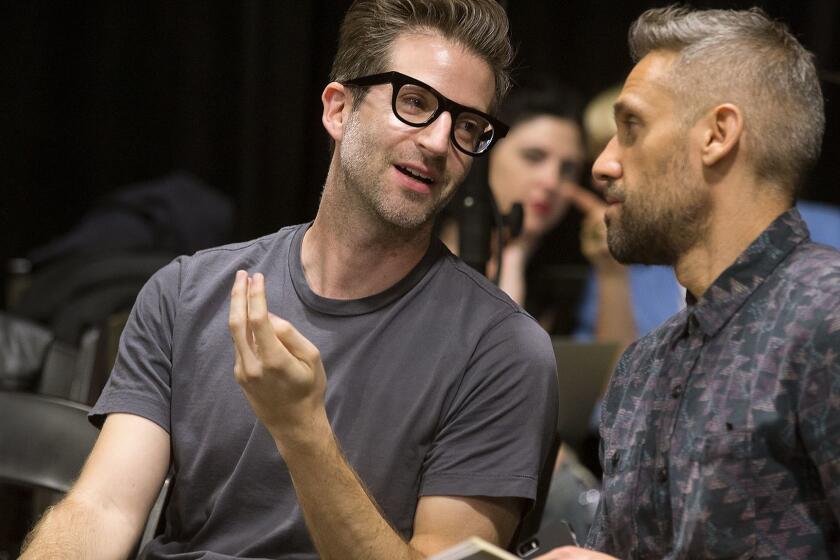 GLENDALE, CA.,March 24, 2016--The Echo Society consists of composers who write for film and TV by day but host an annual concert of orchestral and electronic music set to a light show (this year, Aug. 30 at the Theatre at Ace Hotel). Composers Benjamin Wynn (DERU) and Rob Simonsen talk during rehearsal. (kirk McKoy / Los Angeles Times)