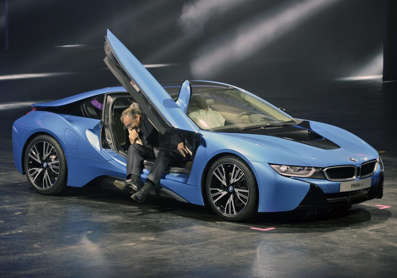 Chairman of BMW, Norbert Reithofer, climbs out of a BMW i8 Hybrid sports car during the press day of the Frankfurt Motor Show (IAA) in Frankfurt, Germany.