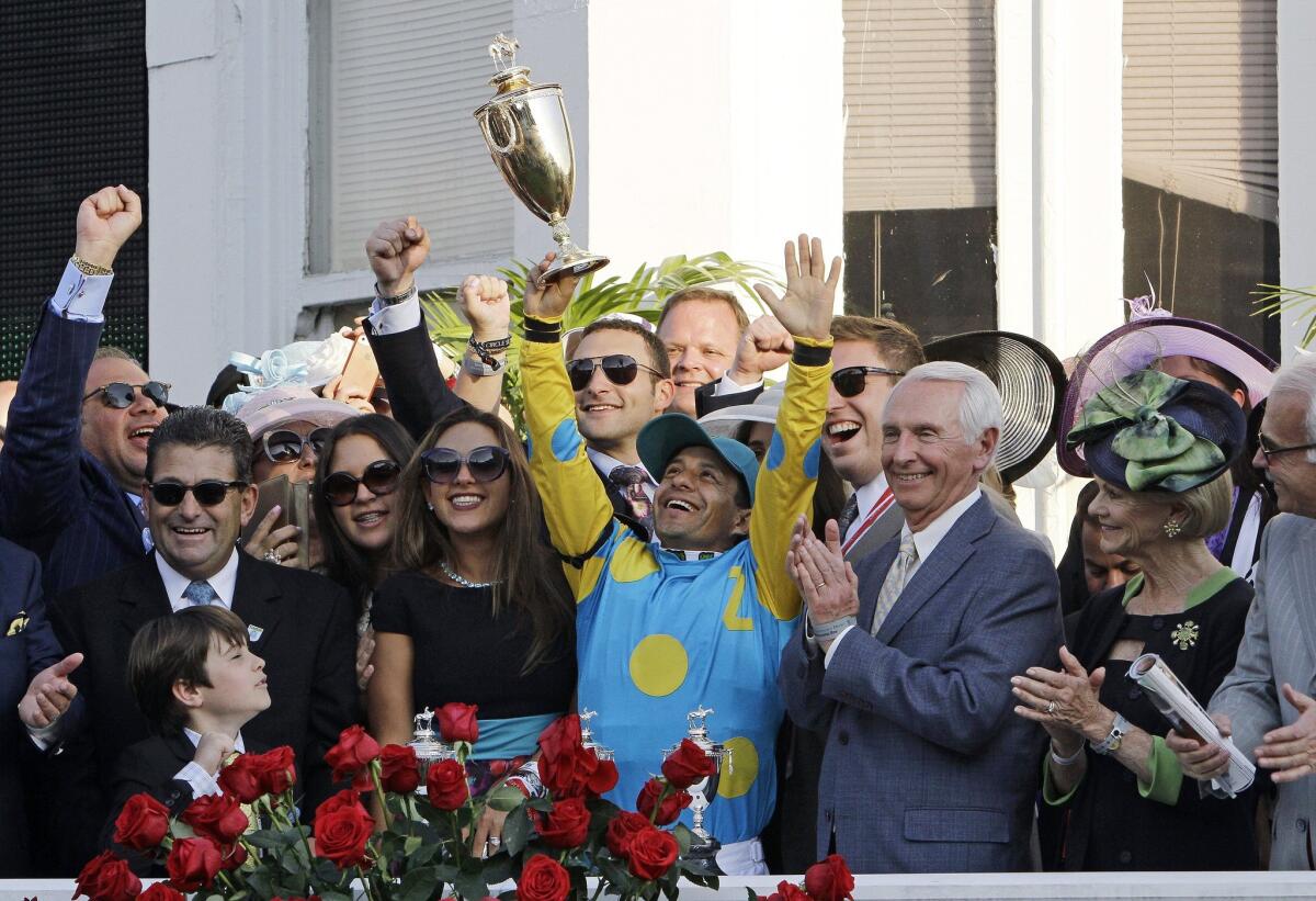 Victor Espinoza celebrates after riding American Pharoah to victory in the 141st running of the Kentucky Derby at Churchill Downs on Saturday.
