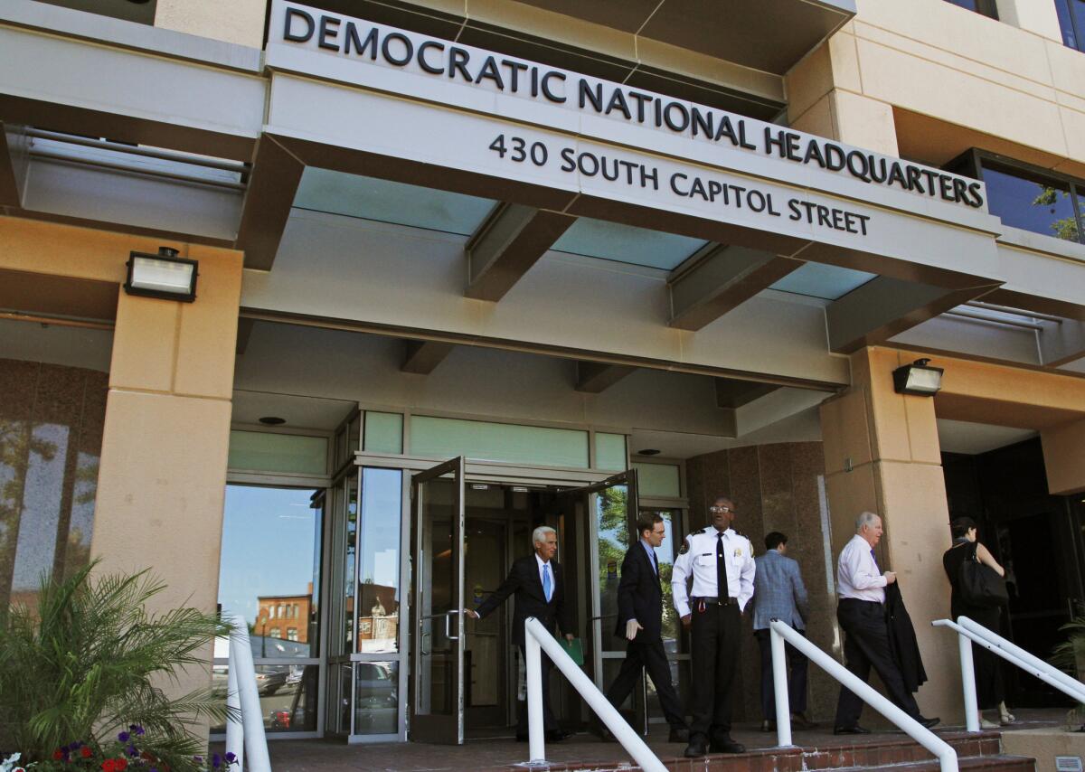 People stand outside the Democratic National Committee headquarters in Washington, D.C., in June.