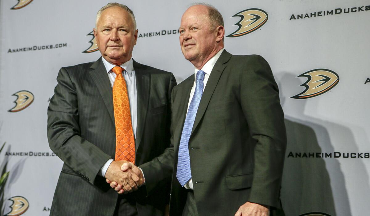 Ducks Executive Vice President and General Manager Bob Murray, right, introduces new Coach Randy Carlyle at a news conference held at Honda Center on Tuesday.