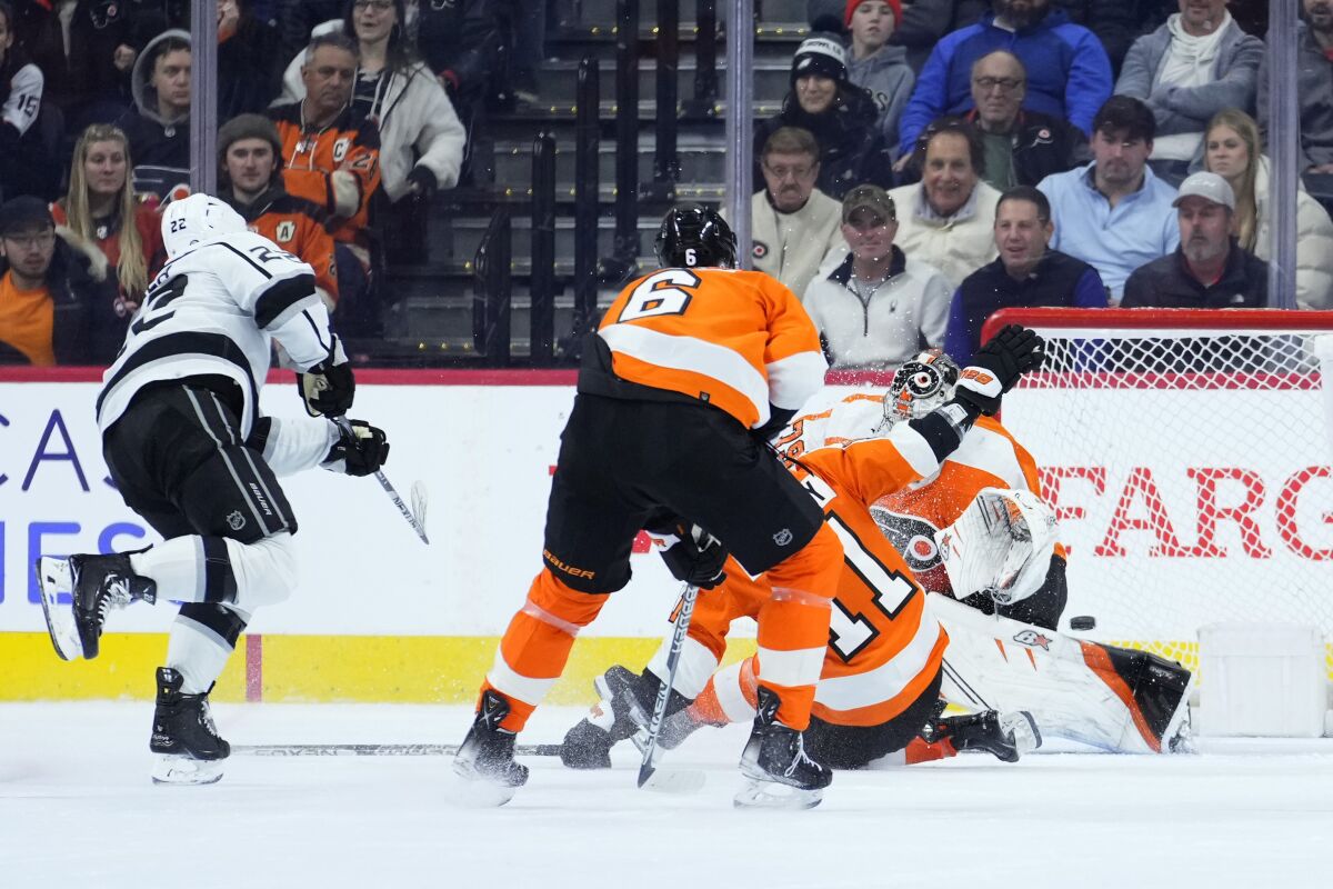 The Kings' Kevin Fiala scores the winning goal against the Flyers' Travis Sanheim, Travis Konecny and Carter Hart.