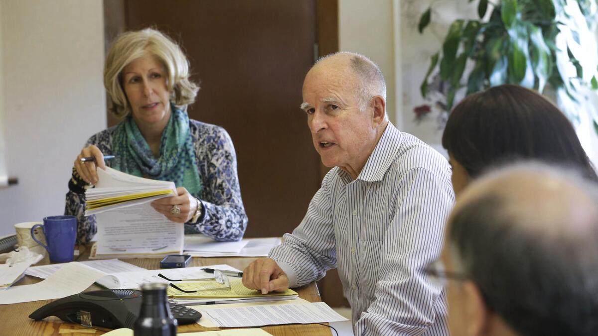 Gov. Jerry Brown at his Capitol office in Sacramento with advisor Nancy McFadden.