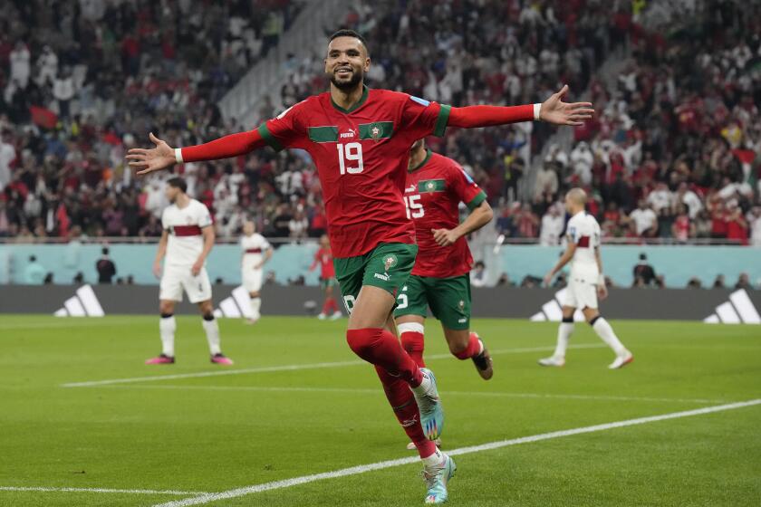 Morocco's Youssef En-Nesyri celebrates after scoring his side's first goal during the World Cup quarterfinal soccer match between Morocco and Portugal, at Al Thumama Stadium in Doha, Qatar, Saturday, Dec. 10, 2022. (AP Photo/Martin Meissner)