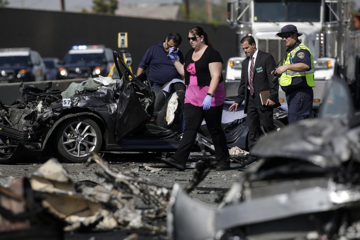 Law enforcement and coroners officials at a fiery crash caused by street racing that killed three people earlier this year on the I-5 Freeway in Commerce.
