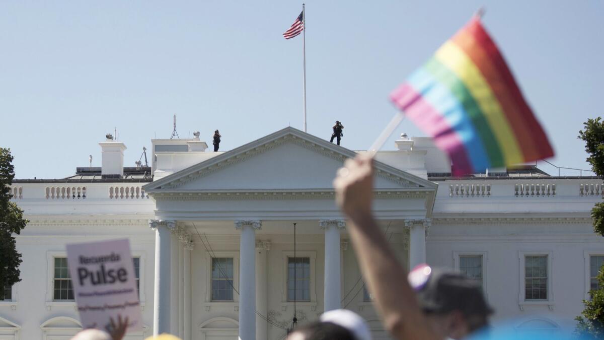 Equality March for Unity and Pride participants march past the White House in Washington on June 11, 2017.