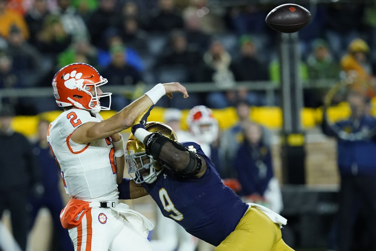 Notre Dame defenseman Justin Ademilola pressures Clemson quarterback Cade Klubnik to throw an interception