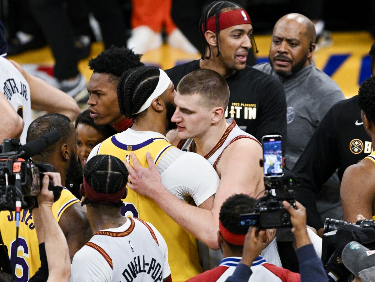 Lakers forward Anthony Davis, left, and Nuggets center Nikola Jokic hug after Game 4.