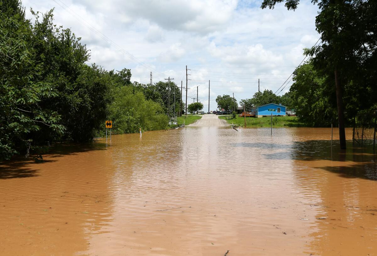 Sixth Street in Rosenberg, Texas is inaccessible due to rising flood waters from the Brazos River on Sunday, May 29, 2016, in Rosenberg, Texas.