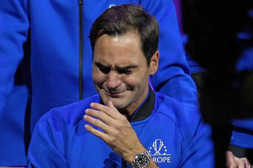 An emotional Roger Federer of Team Europe sits alongside his playing partner Rafael Nadal.