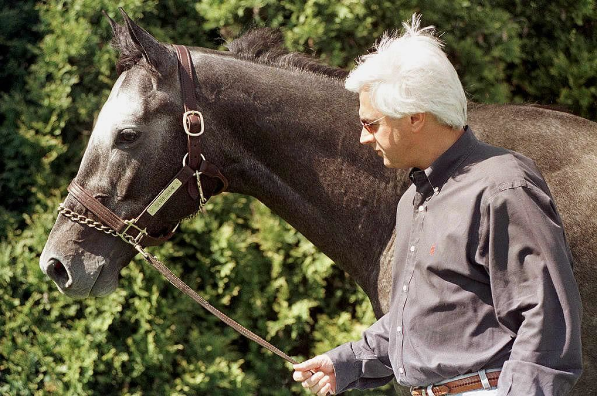 Kentucky Derby winner Silver Charm is walked by trainer Bob Baffert at Pimlico.