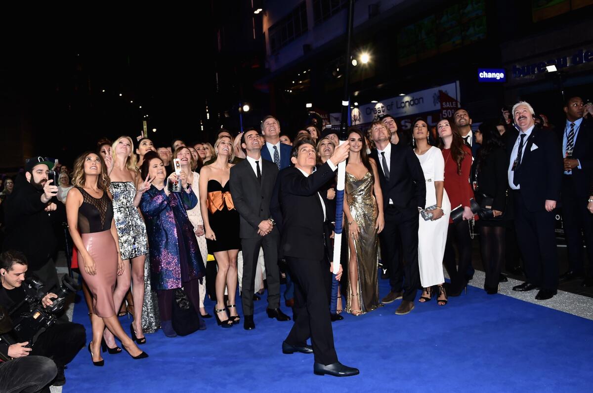 Ben Stiller, center, uses the world's longest selfie stick to take a picture of "Zoolander 2" cast and crew members and guests at the London premiere of the movie.