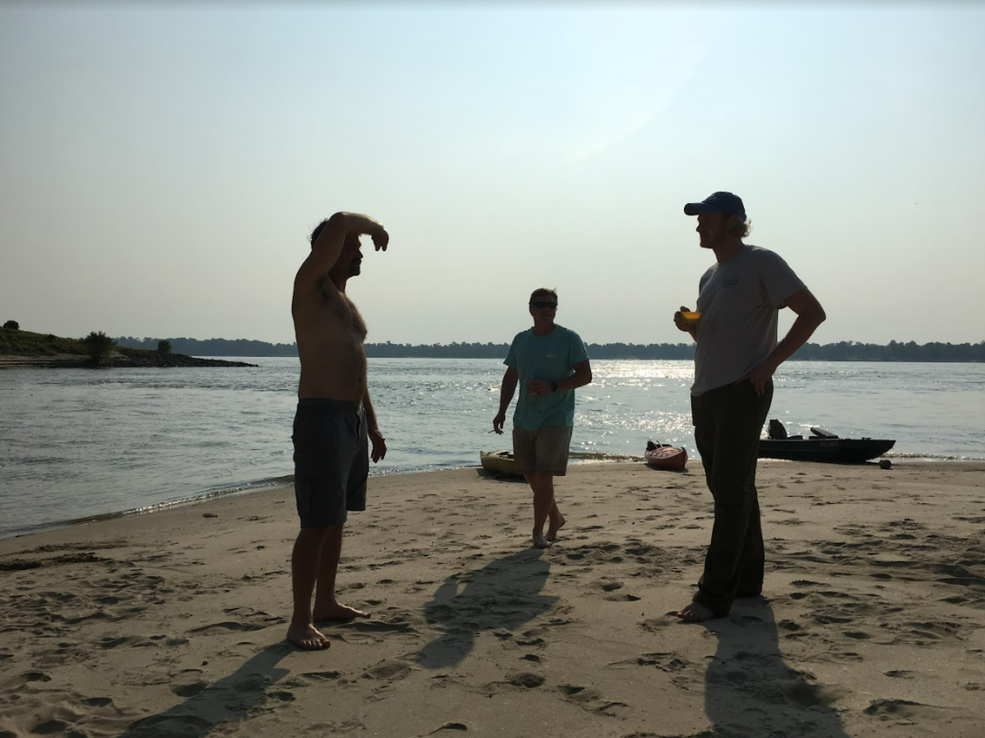 Andrew Cummings (left to right), Thomas Tarver and Christopher Harress stand on the banks of the Mississippi River.