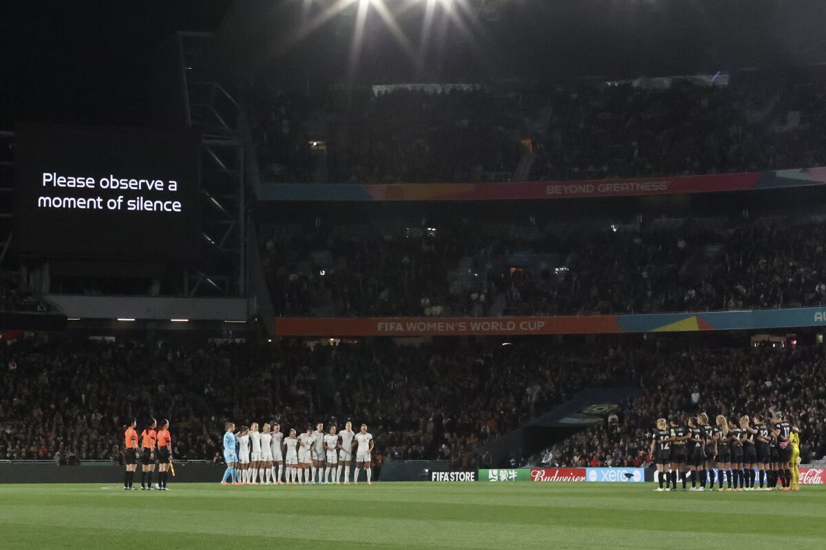 Players observe a moment of silence for the victims of a shooting attack in Auckland, New Zealand, before Thursday's match.