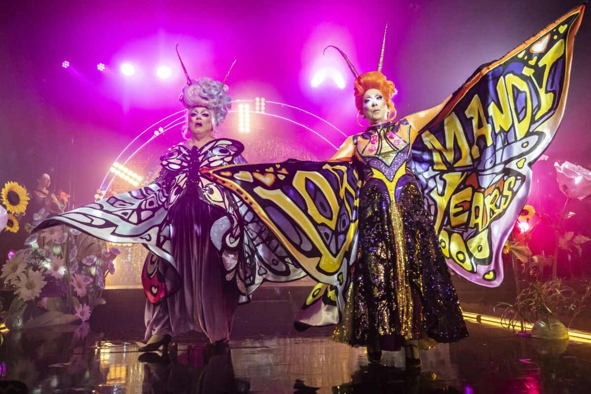 Two performers dressed as butterflies onstage