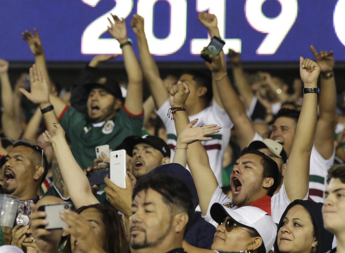 Fans celebrate with hands up after Mexico's 1-0 win over the U.S. in the 2019 CONCACAF Gold Cup final.