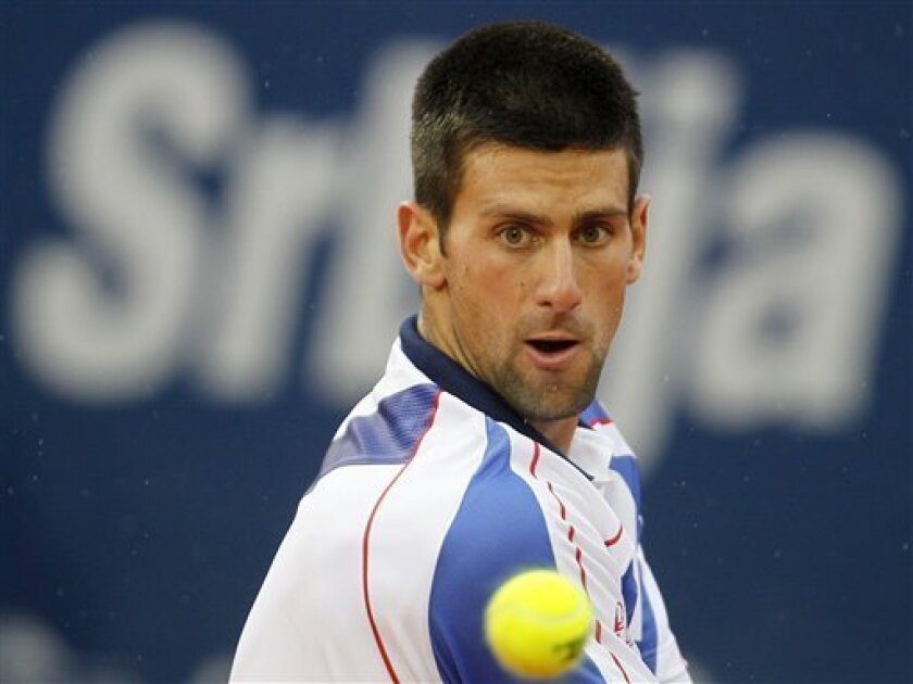 Novak Djokovic of Serbia returns a ball to Feliciano Lopez of Spain during their final tennis match of the Serbia Open tennis tournament in Belgrade, Serbia, Sunday, May 1, 2011. (AP Photo/Darko Vojinovic)