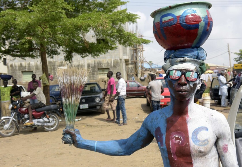 A man wears glasses and body paint adorned with the logo of Nigeria's main opposition party, the All Progressives Congress, as residents await results of the presidential election in Abuja on March 30.