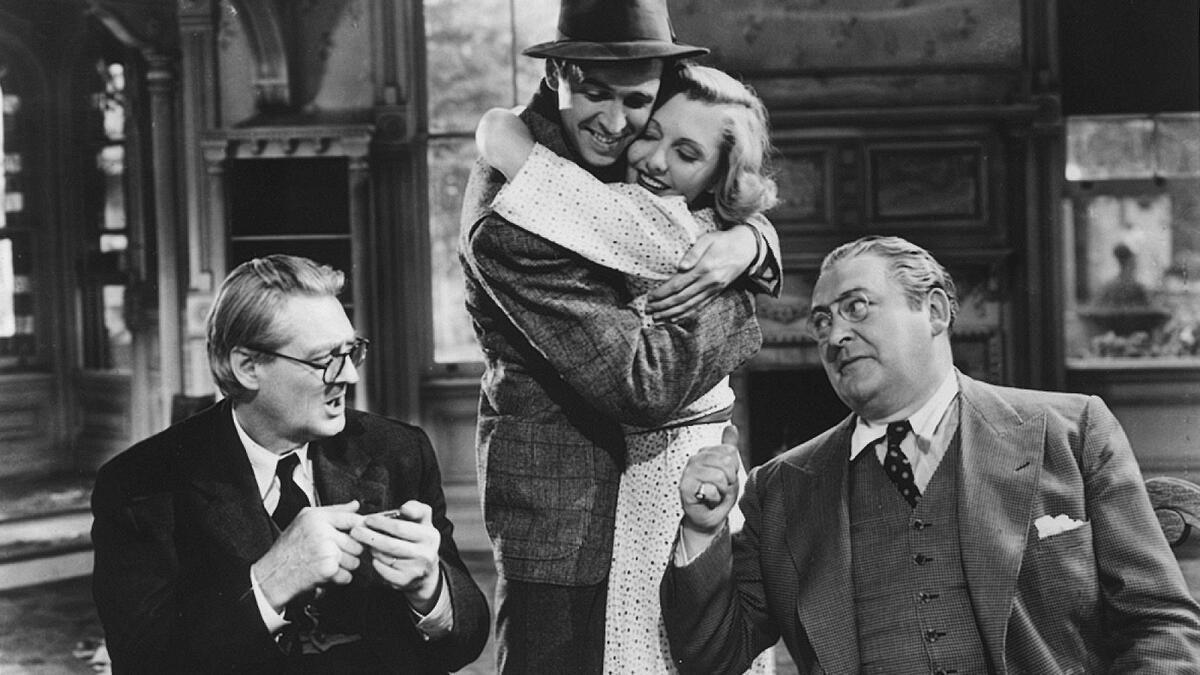 Lionel Barrymore, left, Jimmy Stewart, Jean Arther and Edward Arnold in the movie "You Can't Take it With You."