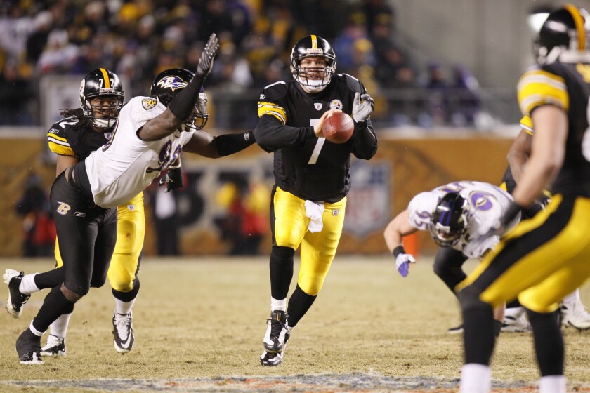 FILE - Pittsburgh Steelers' Ben Roethlisberger shovel passes the ball while being hit by Baltimore Ravens' Trevor Pryce during the second quarter of the NFL AFC championship football game in Pittsburgh, Sunday, Jan. 18, 2009. Roethlisberger will run out onto the Heinz Field turf for the 135th and likely final time on Monday, Jan. 3, 2022, when the Steelers host Cleveland. (AP Photo/Julie Jacobson, File)