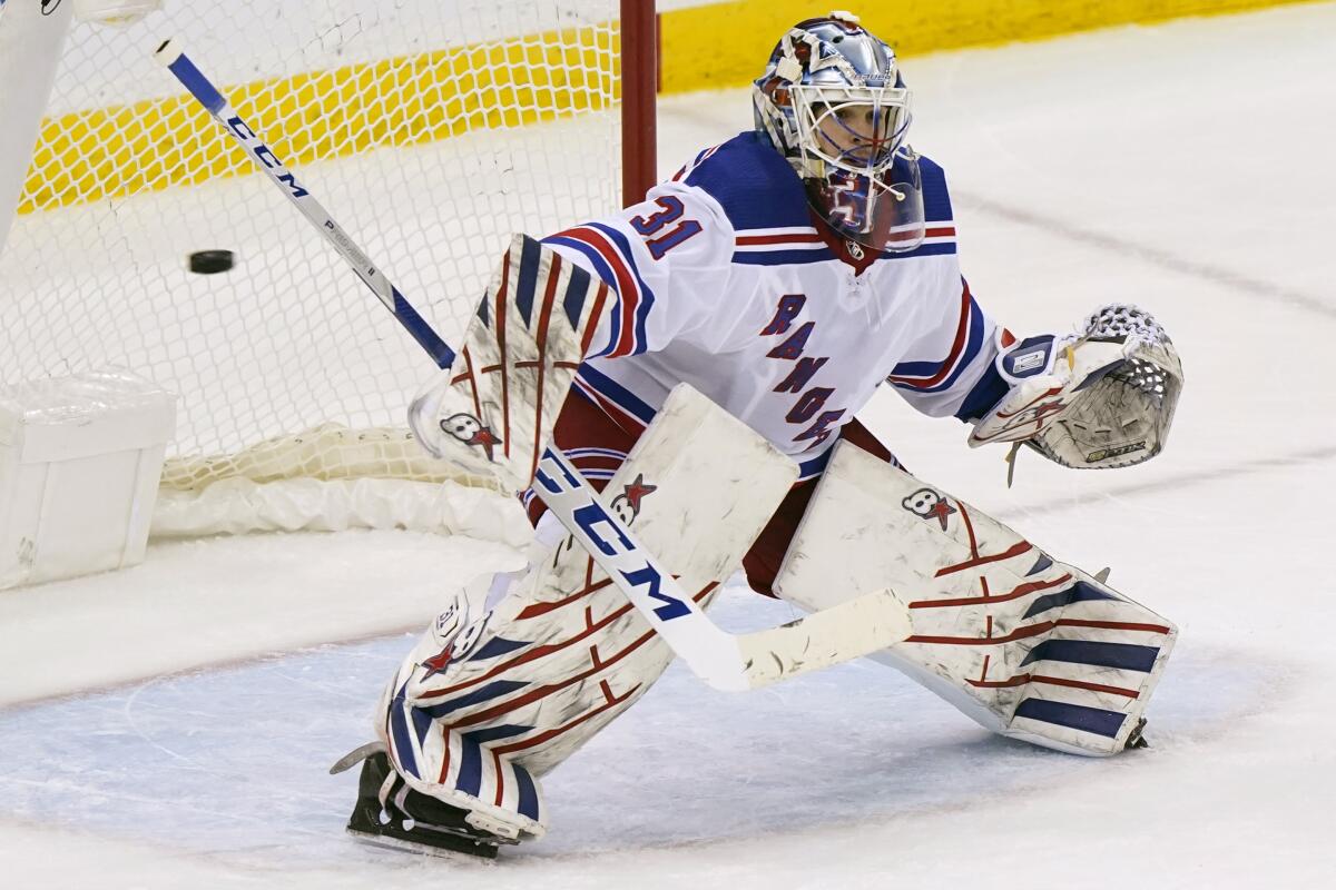 New York Rangers goaltender Igor Shesterkin (31) makes a save during the third period of an NHL hockey game against the New Jersey Devils, Tuesday, April 13, 2021, in Newark, N.J. The Rangers shut out the Devils 3-0. (AP Photo/Kathy Willens)