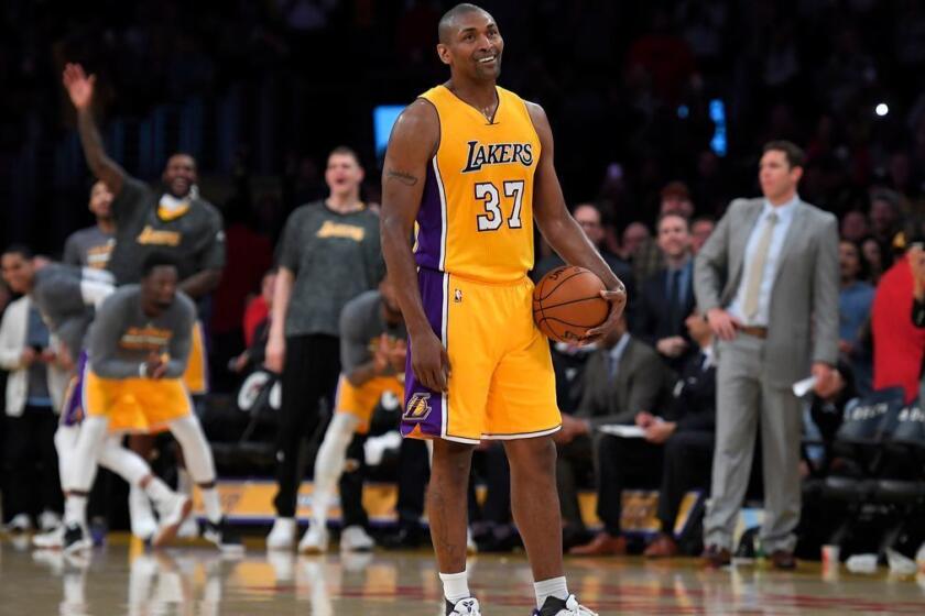 Los Angeles Lakers forward Metta World Peace stands on the court while teammates and fans cheer as the 24 second clock runs out near the end of the team's NBA basketball game against the New Orleans Pelicans, Tuesday, April 11, 2017, in Los Angeles. The Lakers won 108-96. (AP Photo/Mark J. Terrill)