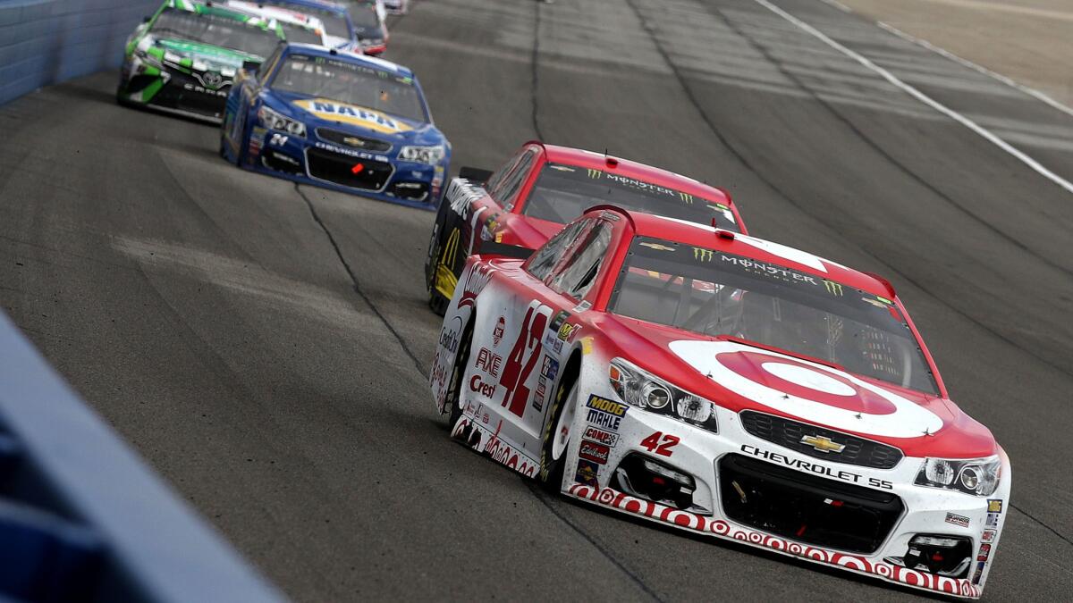 NASCAR driver Kyle Larson leads a pack of cars into a turn during the Monster Energy NASCAR Cup Series Auto Club 400 at Auto Club Speedway on Sunday. (Chris Graythen / Getty Images)