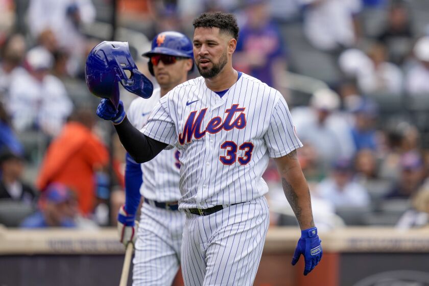 New York Mets' Gary Sanchez reacts after being tagged out at home by Cleveland Guardians catcher Mike Zunino in the fourth inning of the opener of a split doubleheader baseball game, Sunday, May 21, 2023, in New York. (AP Photo/John Minchillo)