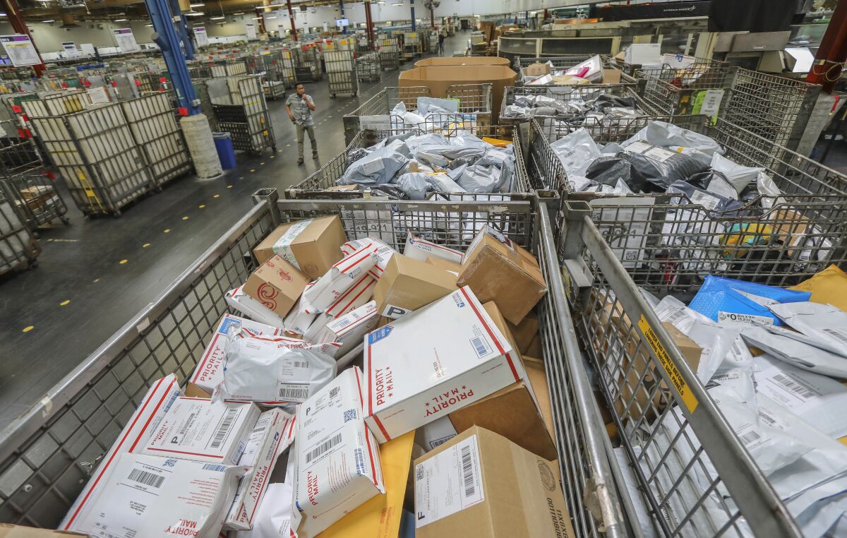 Postal workers sort parcels
