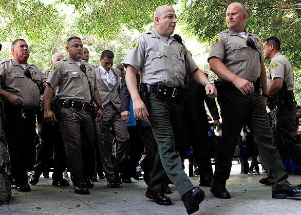 Chris Brown, center, is escorted into Los Angeles County Superior Court for the preliminary hearing of his felony assault case for allegedly hitting and threatening former girlfriend Rihanna after a pre-Grammy party in February.