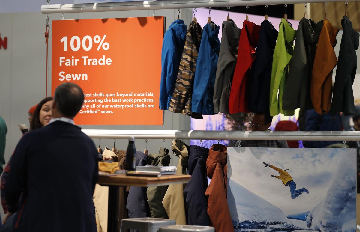 A sign indicating items that were 100% fair trade-sewn marks a rack of jackets 