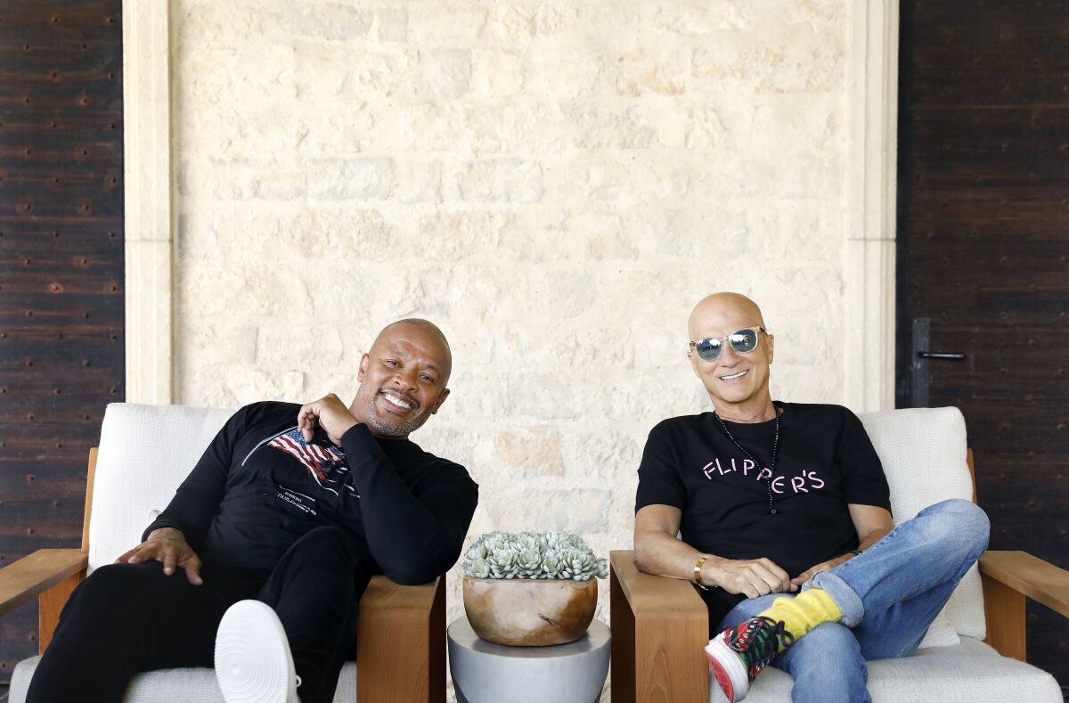 Dr. Dre and Jimmy Iovine, both music moguls from humble roots
